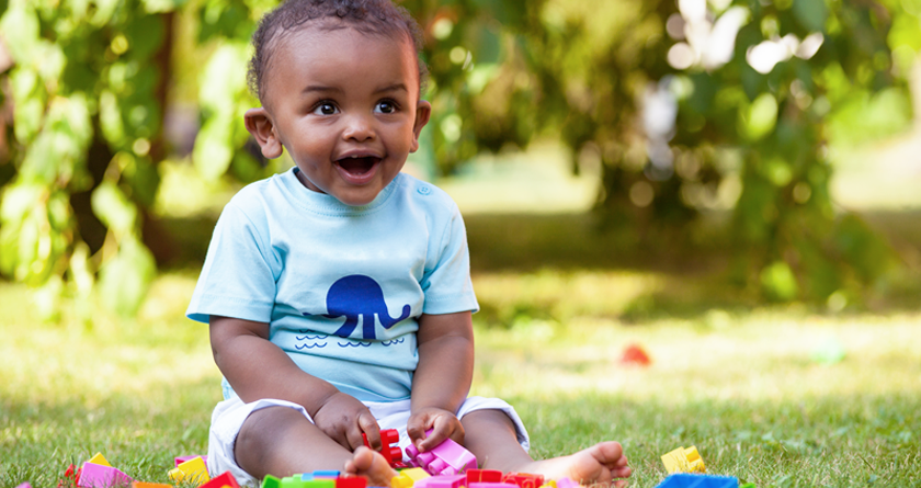 A boy toddler smiling.