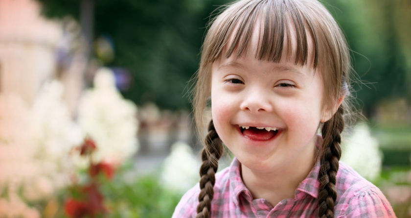 A smiling girl with down syndrome.